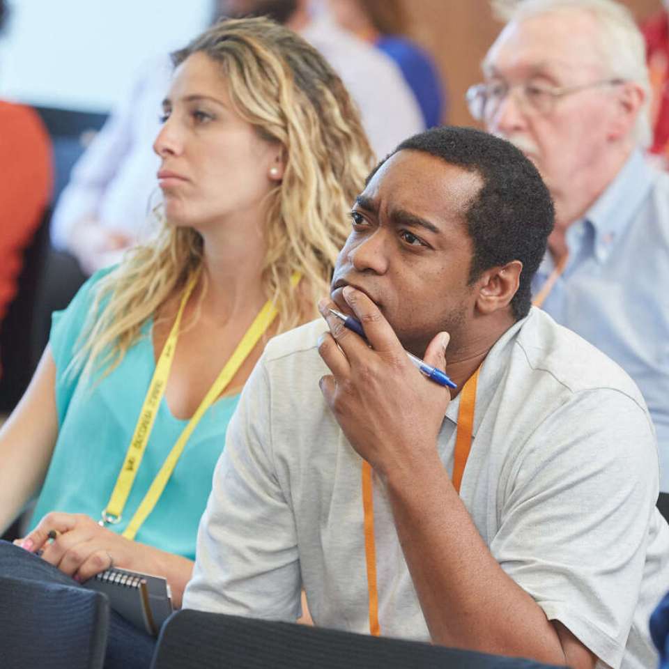 photo of man focusing intensely on a presenation