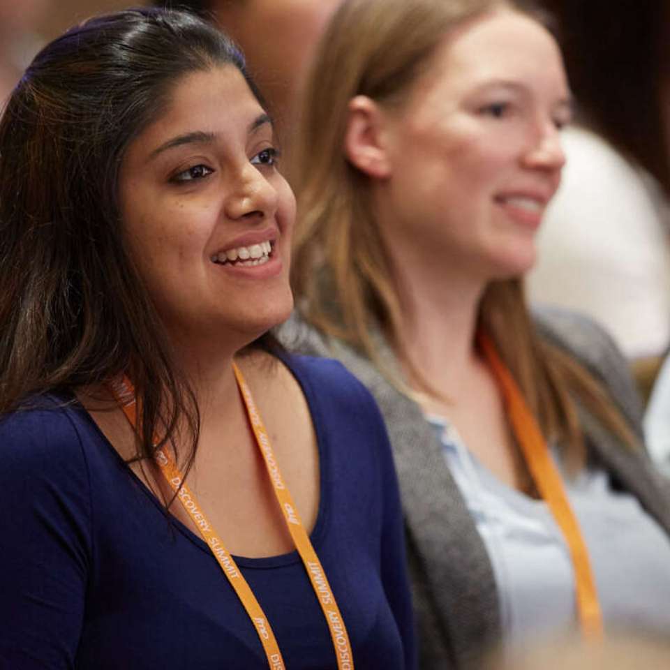 photo of two womene watching a presentation