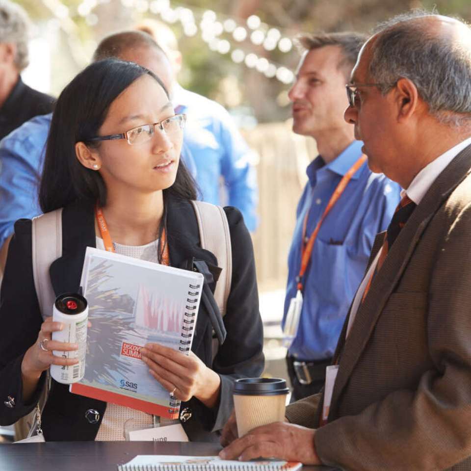 photo of people talking to each other at conference