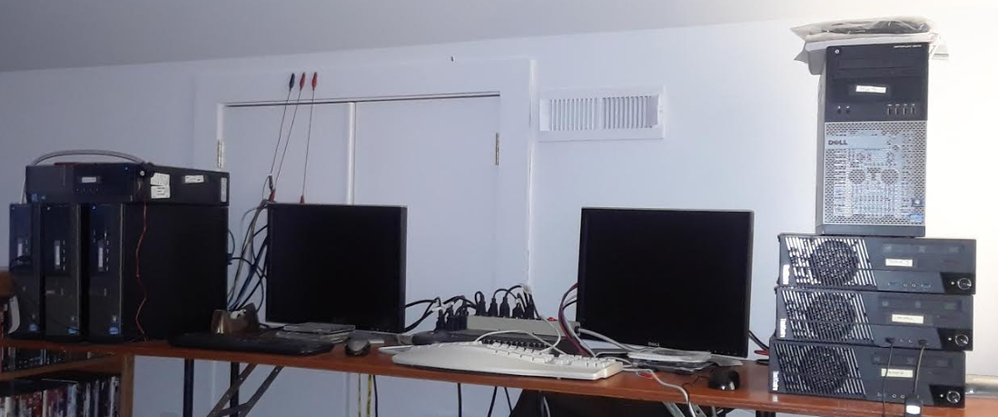 Ethernet hub in center, below power-strip. Not enough mice and monitors and keyboards, SSH is best.