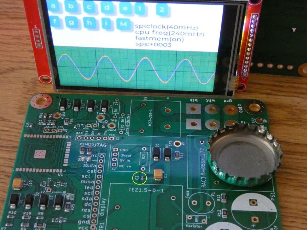 The display is mounted to the red card, which plugs in to a connector mounted to the vertical row of holes at bottom right center.