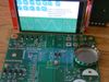 The display is mounted to the red card, which plugs in to a connector mounted to the vertical row of holes at bottom left-center.